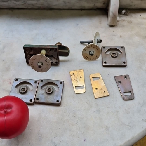 Vintage architectural hardware: brass and steel bathroom door bolt with rotating “VACANT / ENGAGED” indicator disc, associated strike plates and escutcheon covers, 9 pieces total.