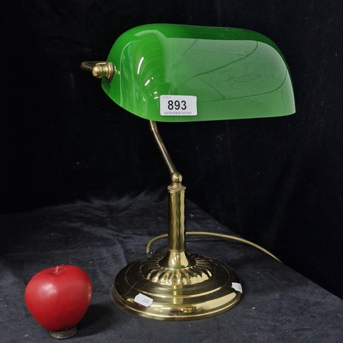 893 - A classic bankers lamp with an emerald green glass shade and brass base.