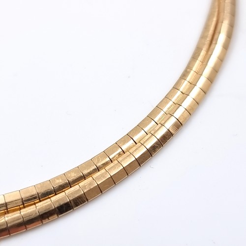 28 - Star Lot: An 18 carat gold 750 twin band bracelet set with safety chain. Weight 15.79 grams.

There ... 