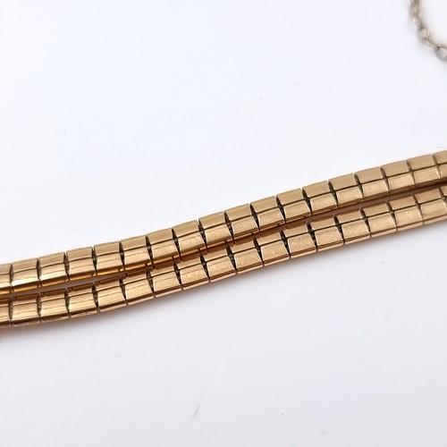 28 - Star Lot: An 18 carat gold 750 twin band bracelet set with safety chain. Weight 15.79 grams.

There ... 