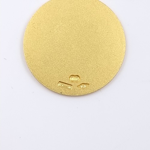 32 - Star Lot: An 18 carat gold 750 religious medallion pendant. Weight 4.43 grams.