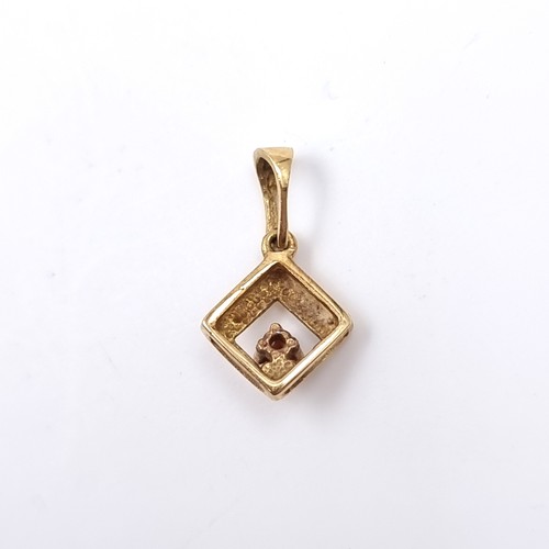 39 - An 18 carat gold 750 ruby set pendant. Weight 0.56 grams.
