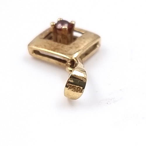 39 - An 18 carat gold 750 ruby set pendant. Weight 0.56 grams.