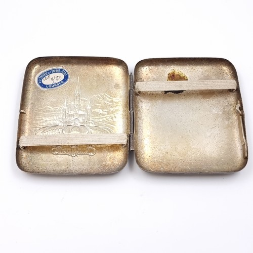 50 - A vintage white metal cigarette case with a Lourdes impressed frontage.