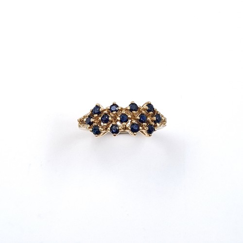5 - Star Lot: An attractive sapphire cluster ring set in nine carat gold. Size L. Weight 3.22 grams.