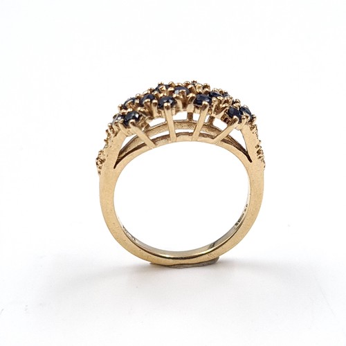 5 - Star Lot: An attractive sapphire cluster ring set in nine carat gold. Size L. Weight 3.22 grams.