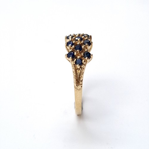 5 - Star Lot: An attractive sapphire cluster ring set in nine carat gold. Size L. Weight 3.22 grams.