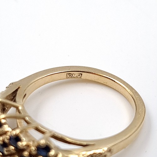 5 - Star Lot: An attractive sapphire cluster ring set in nine carat gold. Size L. Weight 3.22 grams.