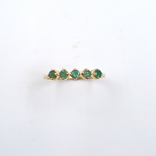 6 - Star Lot: An 18 carat gold emerald half eternity ring. Size O. Weight 1.86 grams.
