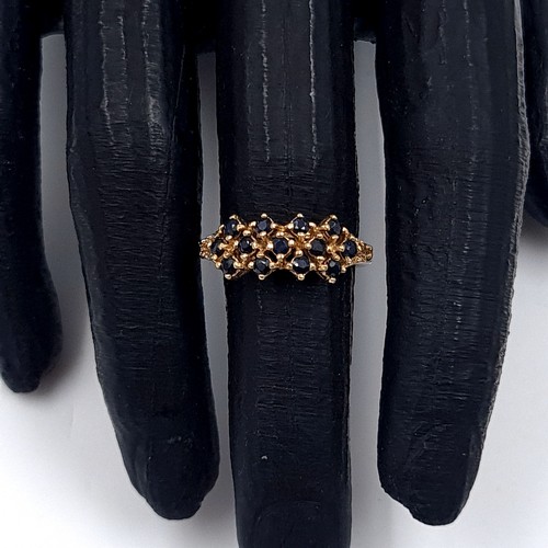 5 - Star Lot: An attractive sapphire cluster ring set in nine carat gold. Size L. Weight 3.22 grams.