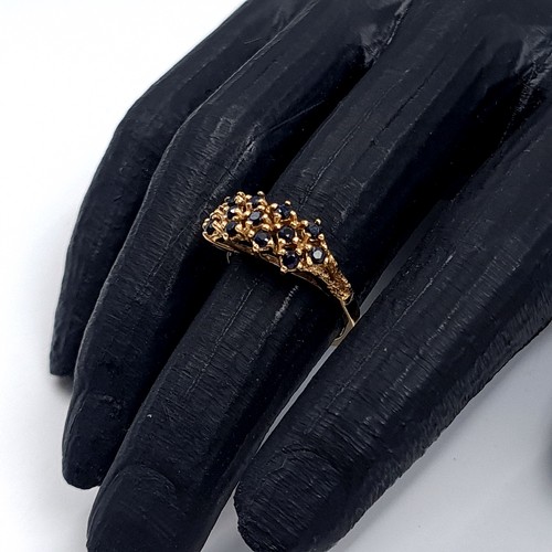 5 - Star Lot: An attractive sapphire cluster ring set in nine carat gold. Size L. Weight 3.22 grams.