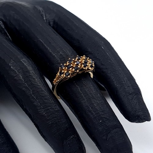 5 - Star Lot: An attractive sapphire cluster ring set in nine carat gold. Size L. Weight 3.22 grams.