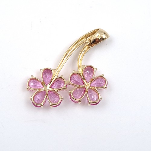 9 - An attractive pink sapphire daisy style pendant set in nine carat gold. Weight 3.7 grams.