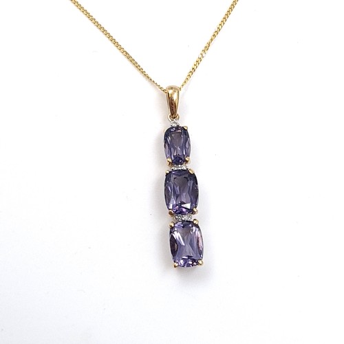 15 - Star Lot: A pretty iolite and diamond pendant necklace set in  nine carat gold. Length of chain 45cm... 