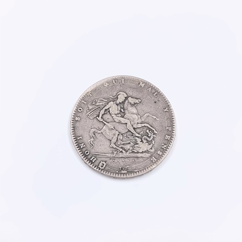 58 - A British silver crown coin from the reign of George III dated 1820 the final year of his reign. Wei... 