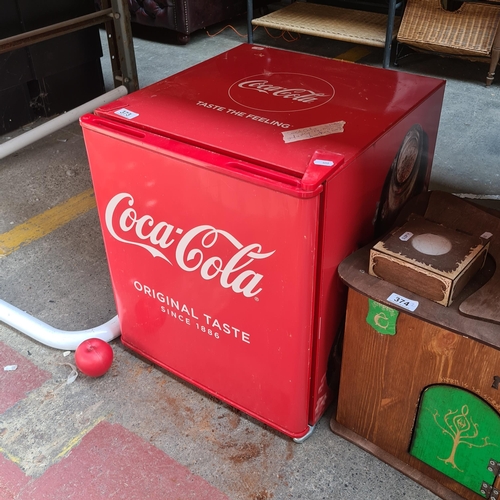 A Coca Cola branded counter top husky fridge in perfect working order. Ideal for home bar use.