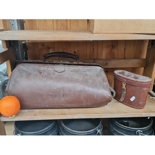 Two early 20th-century brown leather cases comprising a doctor’s Gladstone bag with faded initials and an oval case with red felt lining and binoculars case. From the iconic Georgian home at 4 Henriette Street Dublin 1