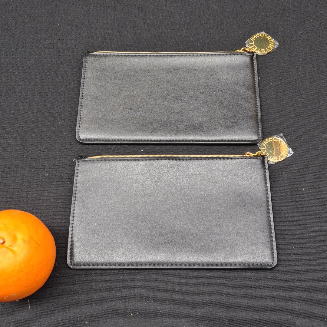 A pair of Stella McCartney black vegan -leather zip purses