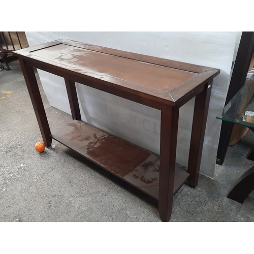 Rectangular wooden console table in dark finish, inset top framed by ...