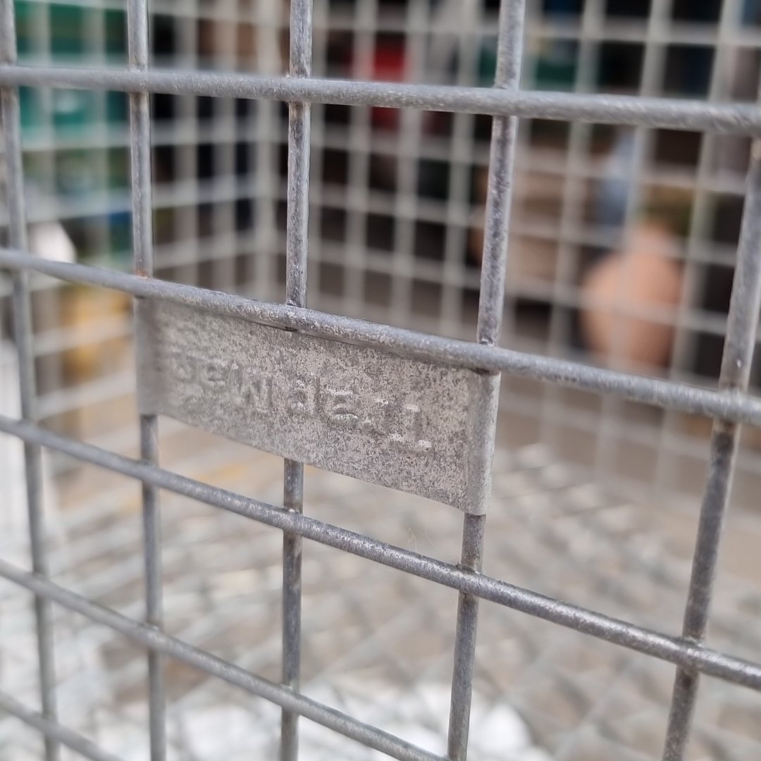 Group of three rectangular galvanized wire mesh cages with hinged ...