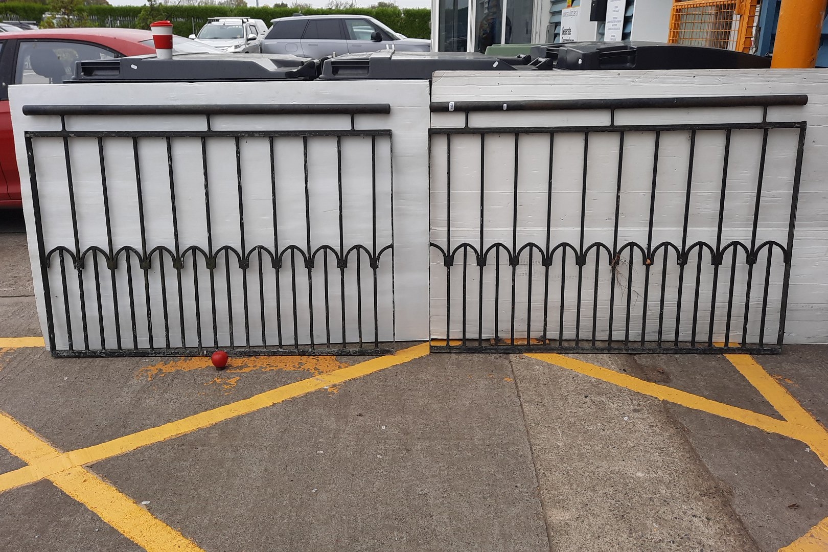 Pair of heavy duty black-painted wrought iron railing panels, each with ...