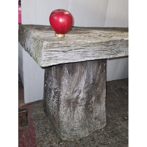 Rustic heavy composite bench, the thick weathered plank seat resting on ...