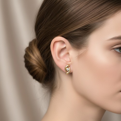 16 - Star lot : A pair of twist design nine carat gold Diamond stud earrings. Weight - 1.5 grams.