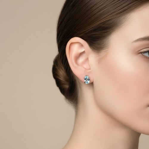 17 - Star Lot : A pretty pair of nine carat gold  twin Topaz stud earrings. Weight - 1 grams.
