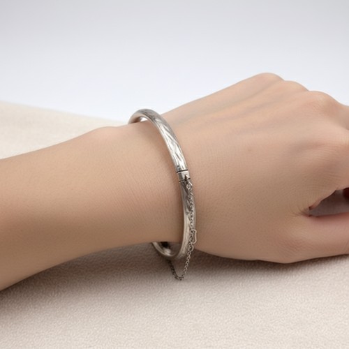 55 - A Sterling Silver bracelet together with safety chain. Weight - 7. 14 grams.