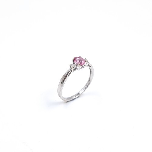 46 - Star Lot : A lovely nine carat white gold ring set with a Pink Sapphire and two Diamonds to shoulder... 
