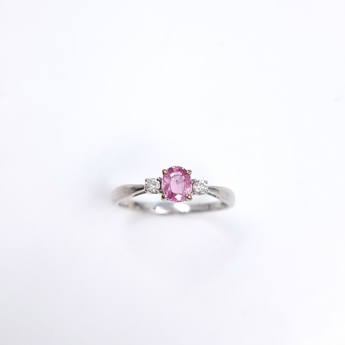 46 - Star Lot : A lovely nine carat white gold ring set with a Pink Sapphire and two Diamonds to shoulder... 