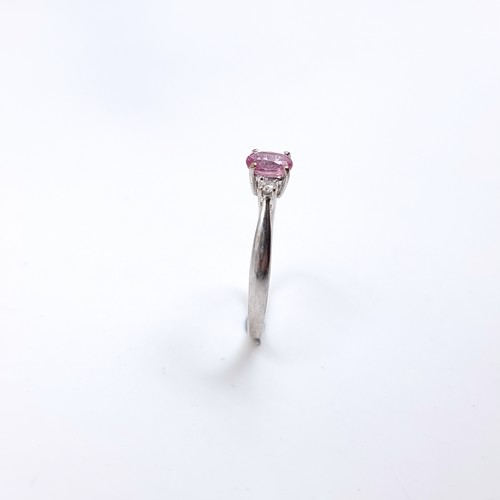 46 - Star Lot : A lovely nine carat white gold ring set with a Pink Sapphire and two Diamonds to shoulder... 