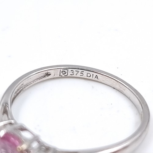 46 - Star Lot : A lovely nine carat white gold ring set with a Pink Sapphire and two Diamonds to shoulder... 