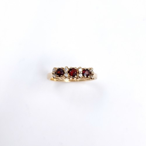 43 - Star Lot : A Three Garnet and White Tourmaline 375 nine carat gold. Size - P, Weight - 2.73 grams.