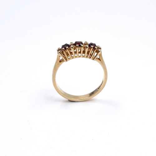43 - Star Lot : A Three Garnet and White Tourmaline 375 nine carat gold. Size - P, Weight - 2.73 grams.