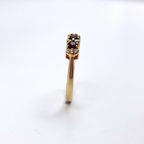 43 - Star Lot : A Three Garnet and White Tourmaline 375 nine carat gold. Size - P, Weight - 2.73 grams.