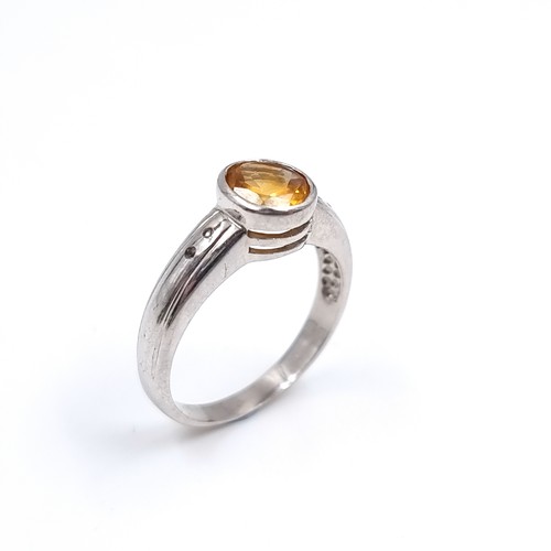 42 - A nine carat white gold ring set with a large Citrine stone. Size - P, Weight - 3.48 grams.
