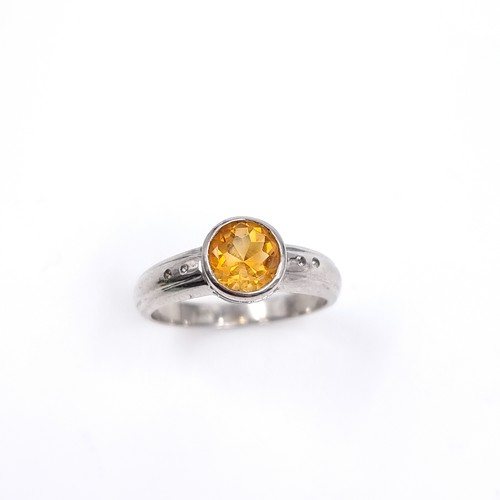 42 - A nine carat white gold ring set with a large Citrine stone. Size - P, Weight - 3.48 grams.