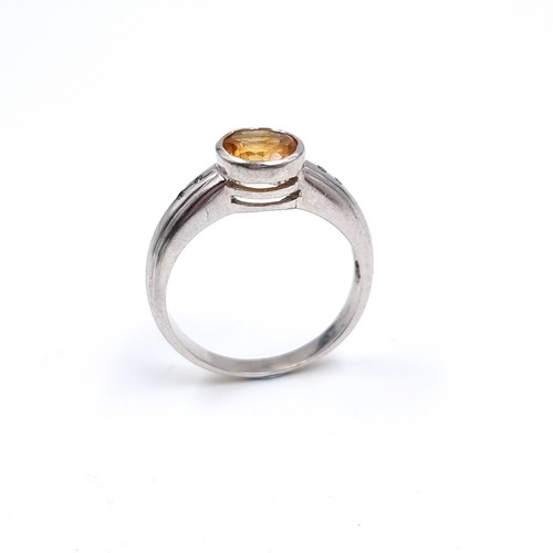 42 - A nine carat white gold ring set with a large Citrine stone. Size - P, Weight - 3.48 grams.
