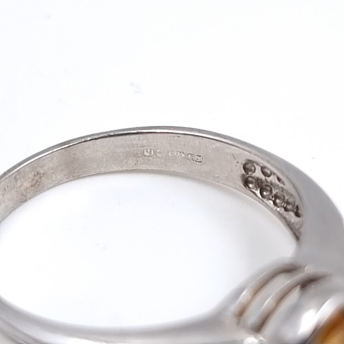 42 - A nine carat white gold ring set with a large Citrine stone. Size - P, Weight - 3.48 grams.