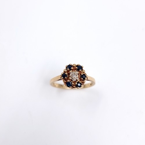 41 - Star Lot : A Diamond and Sapphire daisy style ring set in 375 nine carat gold. Size - L, Weight - 2.... 