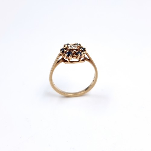 41 - Star Lot : A Diamond and Sapphire daisy style ring set in 375 nine carat gold. Size - L, Weight - 2.... 