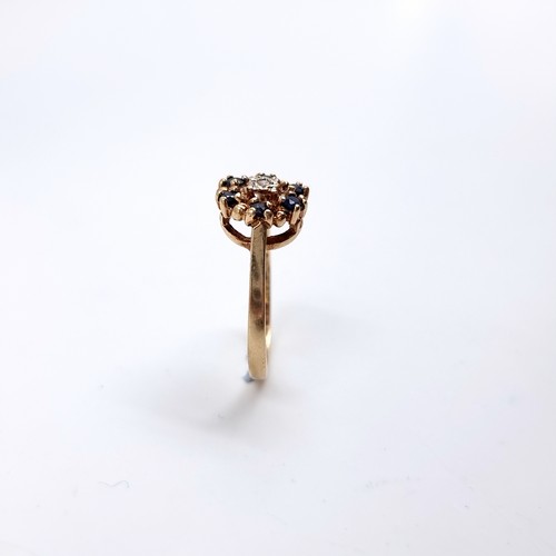 41 - Star Lot : A Diamond and Sapphire daisy style ring set in 375 nine carat gold. Size - L, Weight - 2.... 