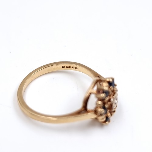 41 - Star Lot : A Diamond and Sapphire daisy style ring set in 375 nine carat gold. Size - L, Weight - 2.... 