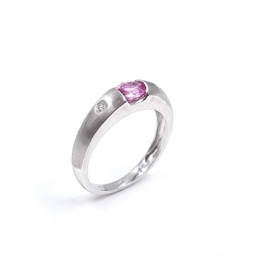 40 - Star Lot : A nine carat white gold ring set with a Pink Sapphire and two Diamonds. Size - P, Weight ... 