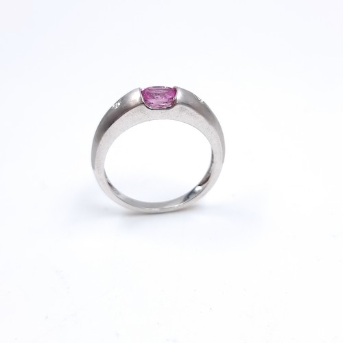 40 - Star Lot : A nine carat white gold ring set with a Pink Sapphire and two Diamonds. Size - P, Weight ... 