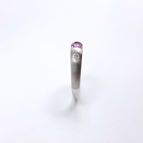 40 - Star Lot : A nine carat white gold ring set with a Pink Sapphire and two Diamonds. Size - P, Weight ... 