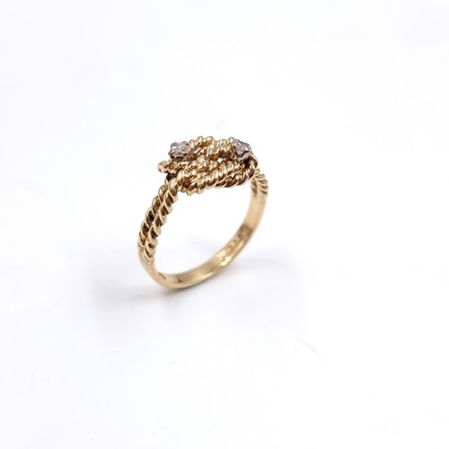35 - Star Lot : A twist set nine carat gold ring with Diamonds . Size - O, Weight - 2.77 grams.