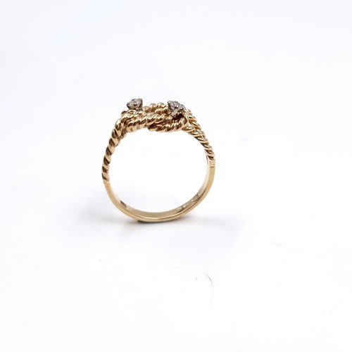 35 - Star Lot : A twist set nine carat gold ring with Diamonds . Size - O, Weight - 2.77 grams.