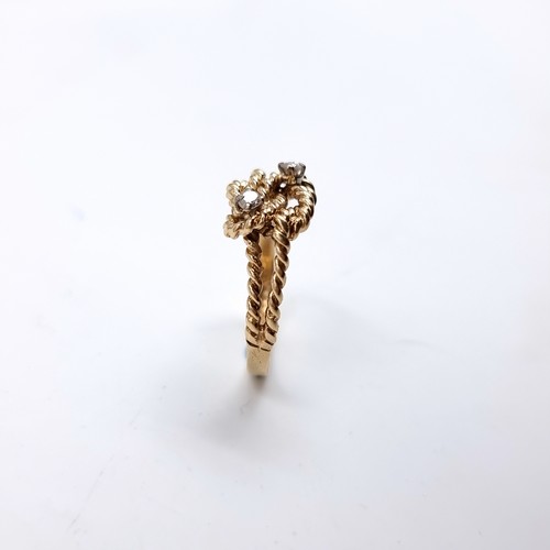 35 - Star Lot : A twist set nine carat gold ring with Diamonds . Size - O, Weight - 2.77 grams.